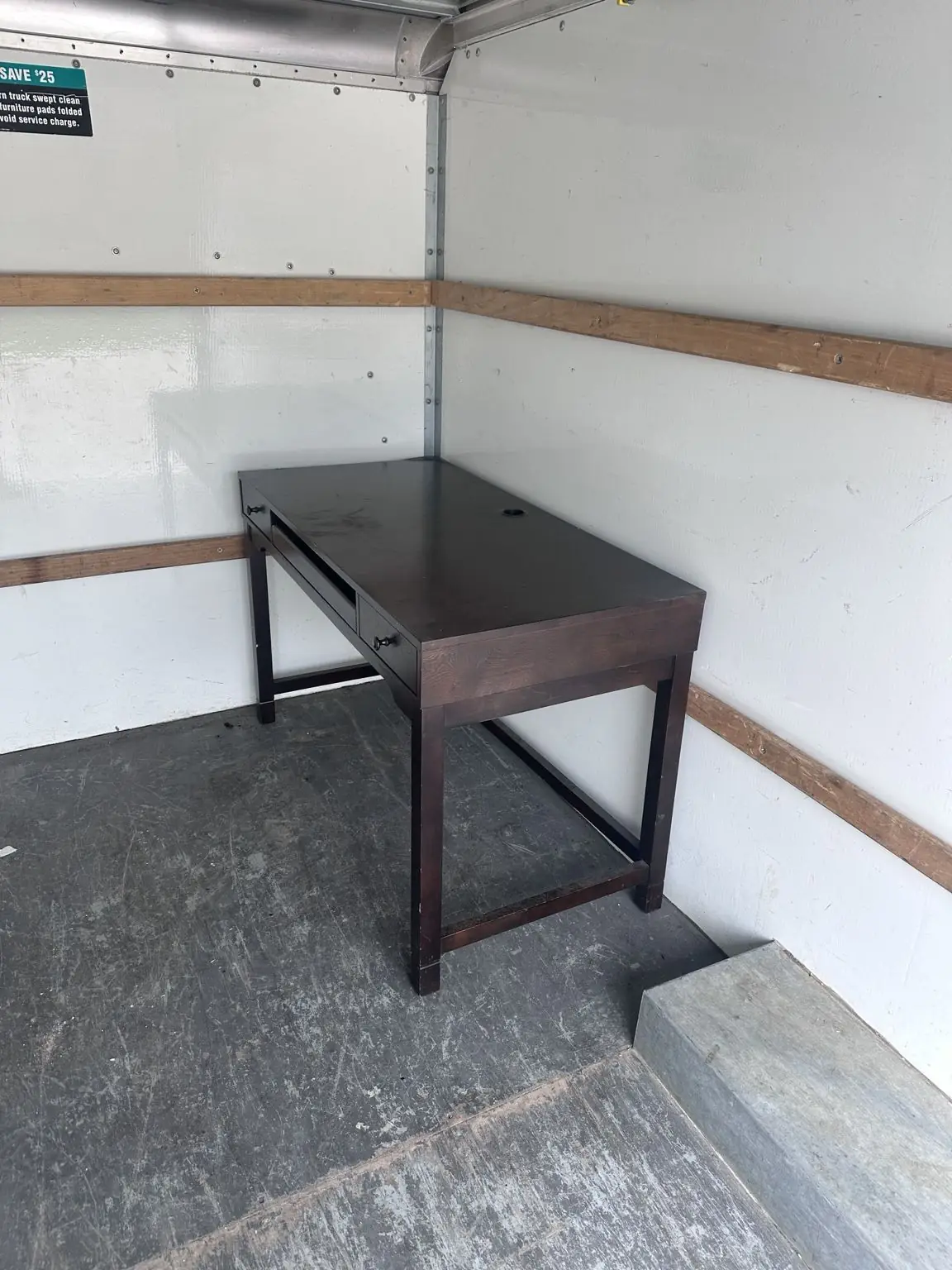 Furniture Pickup - Desk picked up and secured for removal.